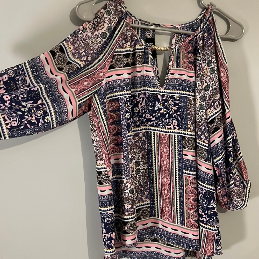 Open shoulder, business casual, multi colored, multi patterned top.